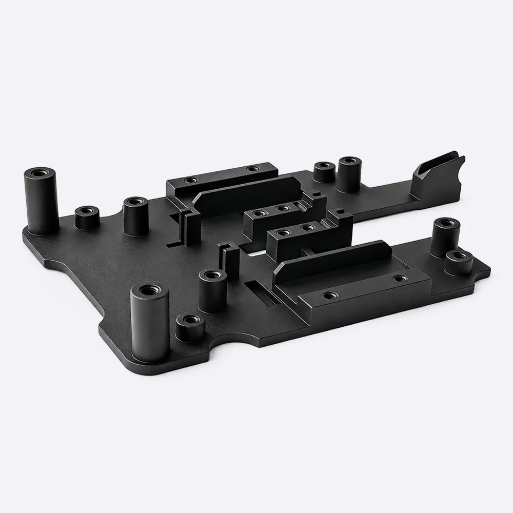 Black painted SLA resin fixture with bosses, threaded openings and locating features.