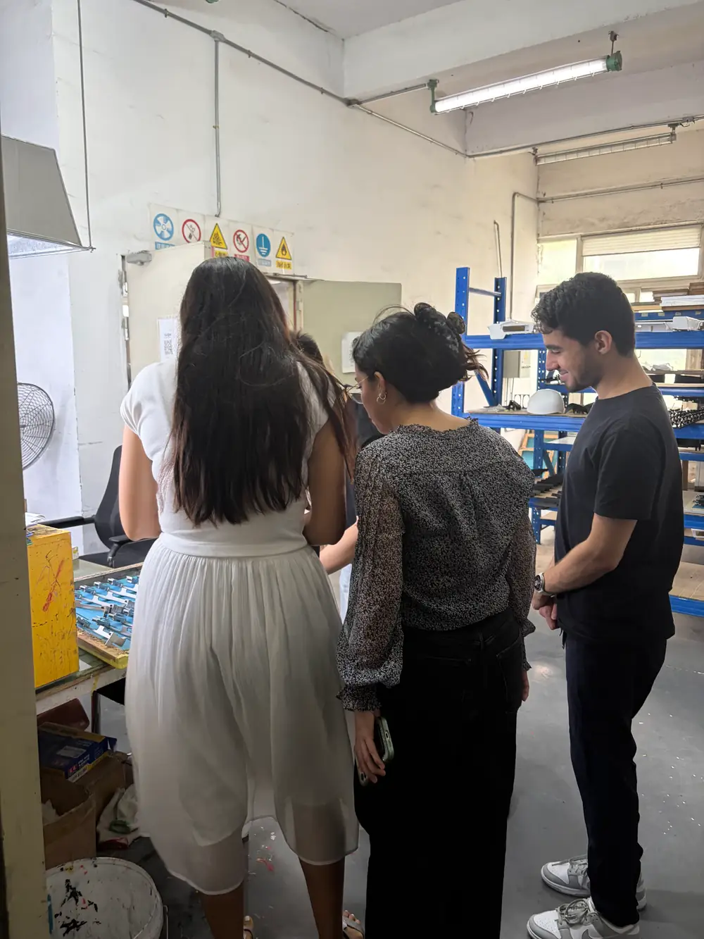 Visiting customers reviewing manufactured components with the HERUIYUN team