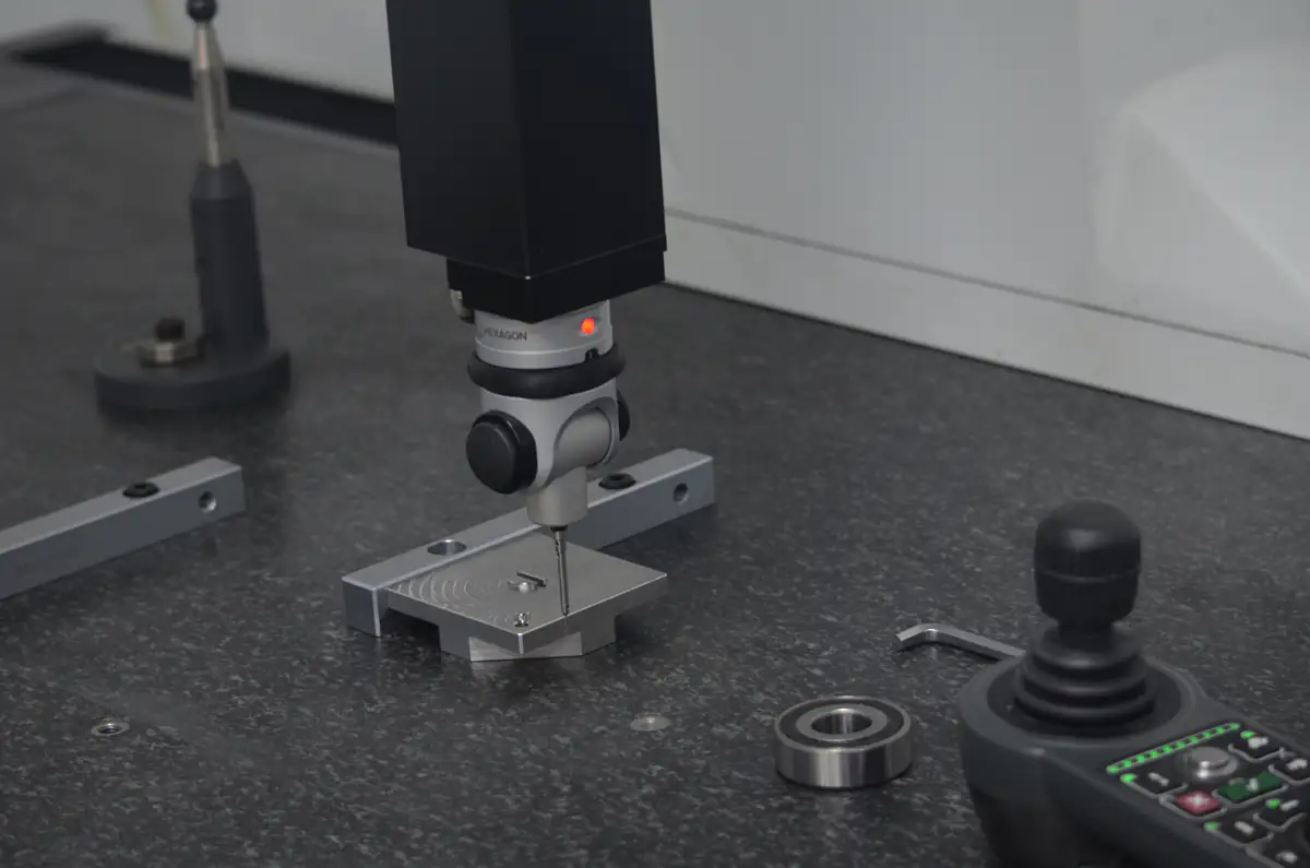Coordinate measuring machine inspecting a machined metal component