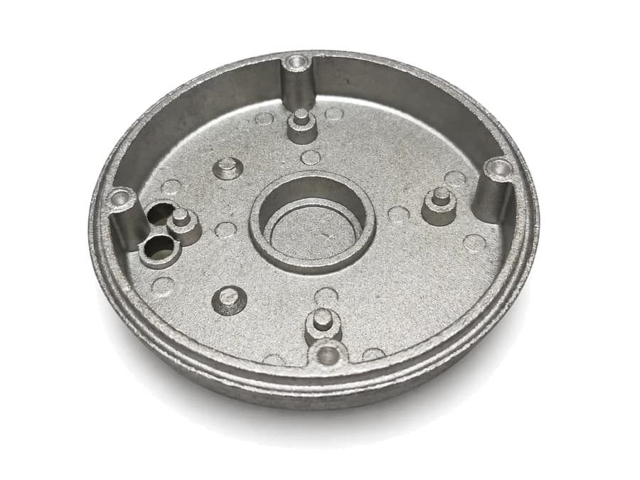 Representative circular die-cast metal component on a white background