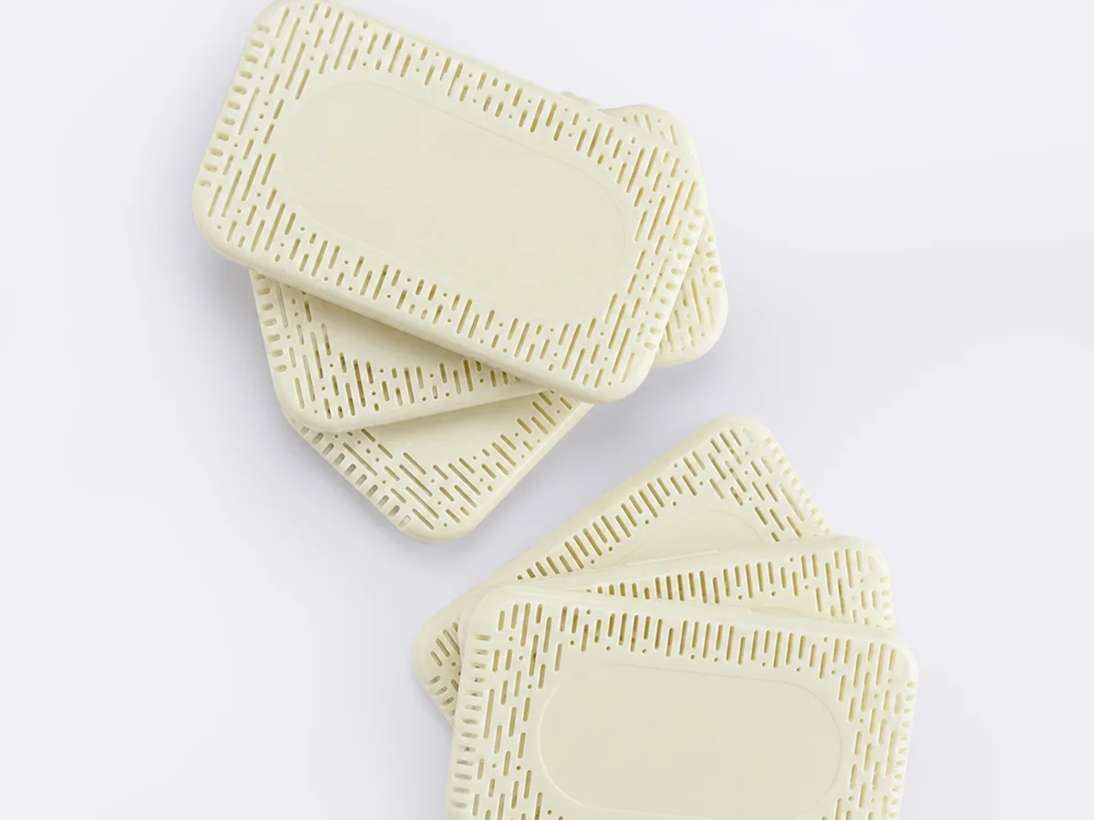 White SLA resin prototype parts with fine lattice and rib details