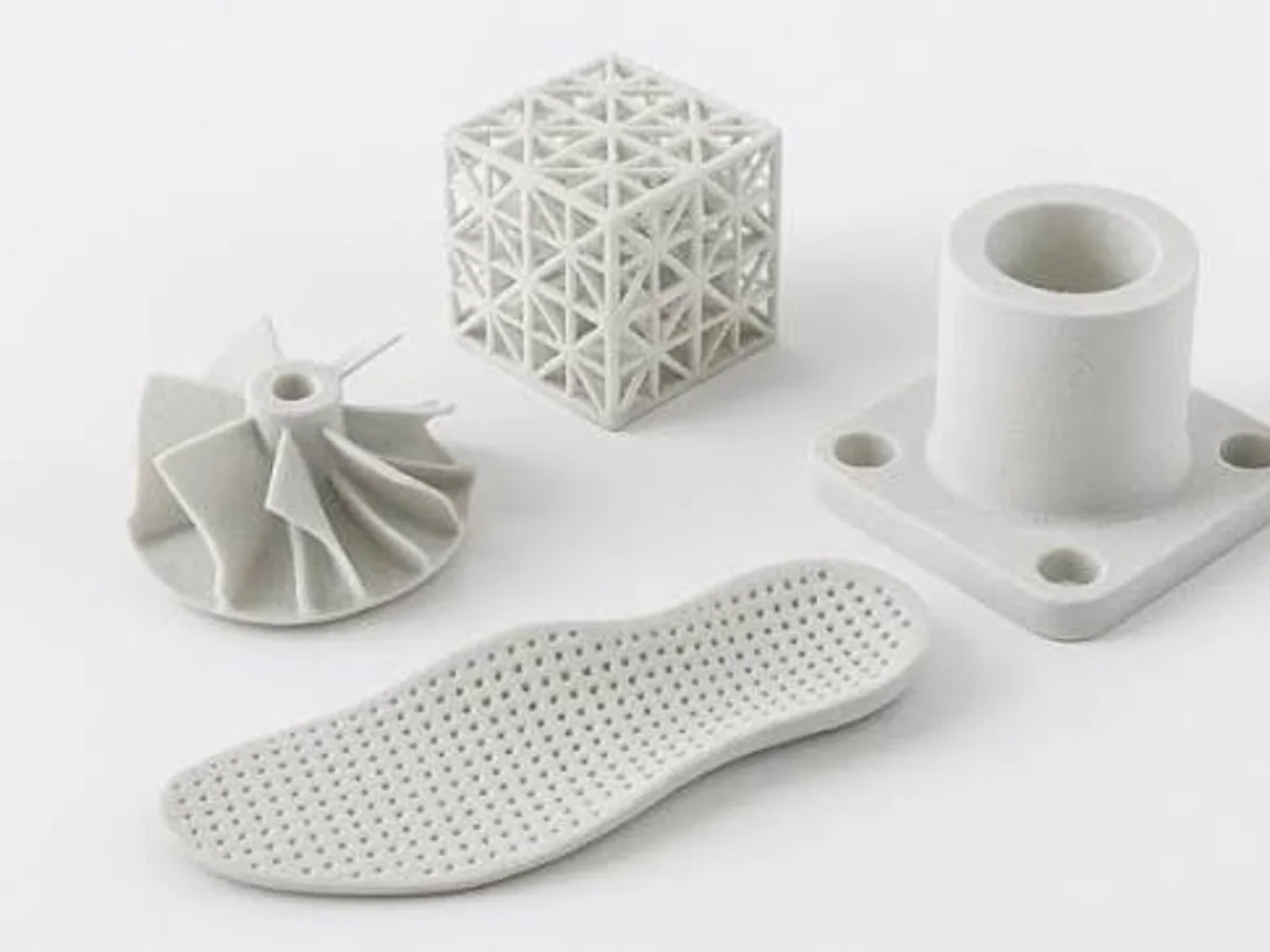 White SLS nylon sample parts showing lattice, rib and housing geometry